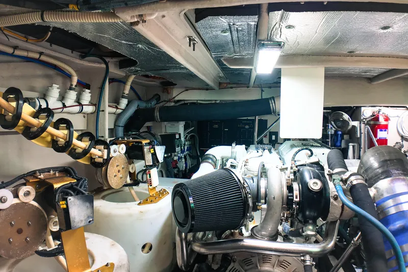 Slide: The Image of Engine room of a 2016 Sea Ray L590 Fly yacht, showcasing mechanical components and systems. - 30