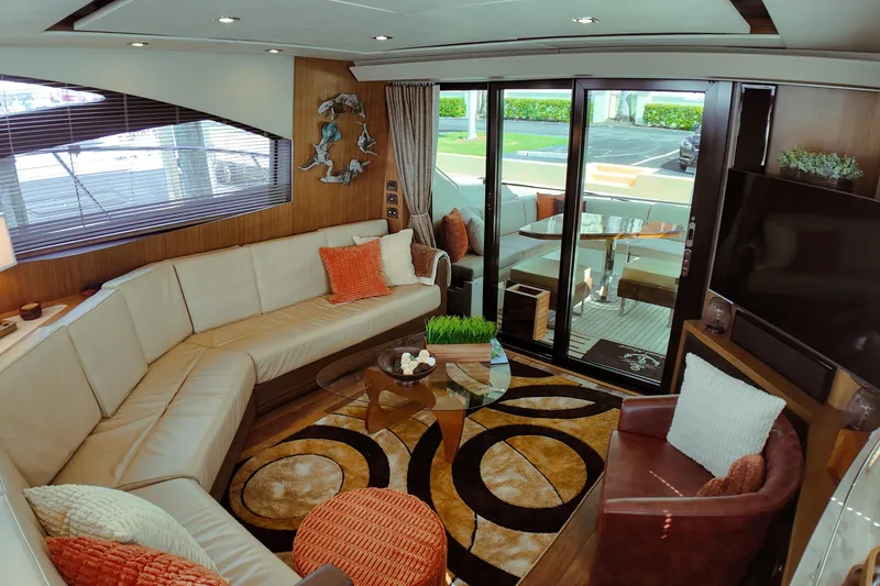 Slide: The Image of Luxurious 2016 Sea Ray L590 Fly yacht with elegant seating and polished wooden table. - 6