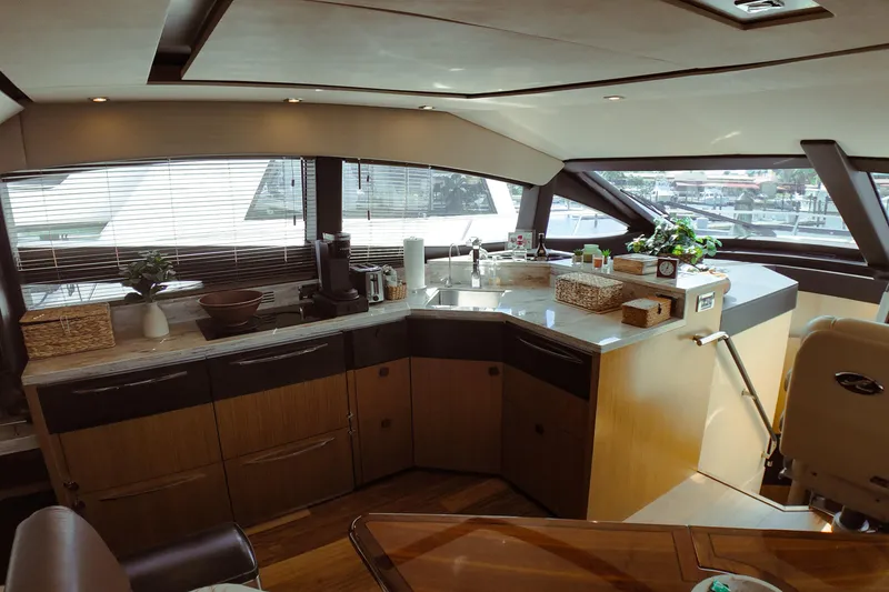 Slide: The Image of Luxurious interior of 2016 Sea Ray L590 Fly yacht with helm and seating area. - 8