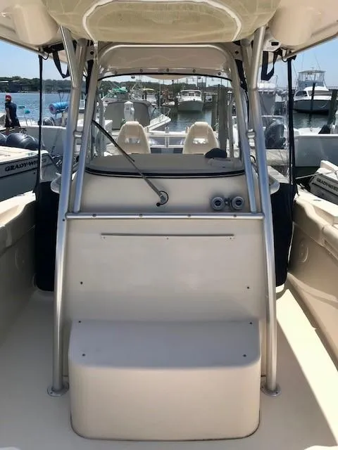 Slide: The Image of 2015 Grady-White Canyon 306 boat interior with helm and seating, docked at marina. - 11