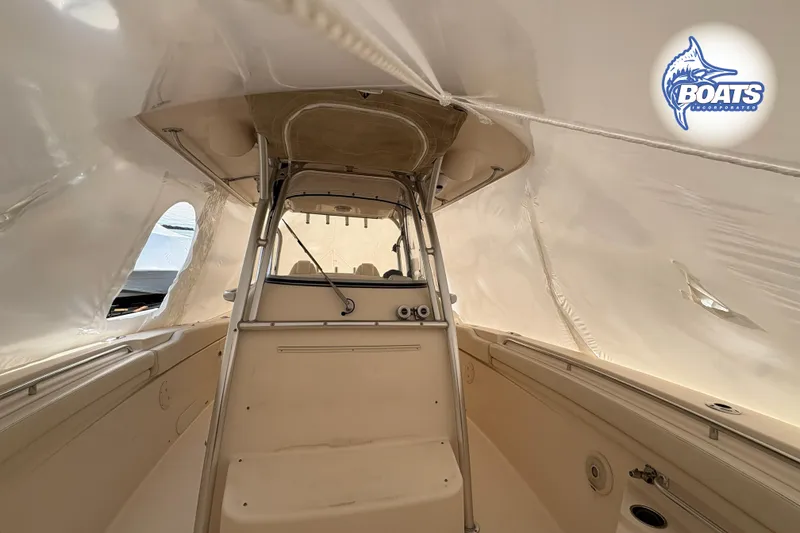 Slide: The Image of 2015 Grady-White Canyon 306 boat interior under protective cover. - 12