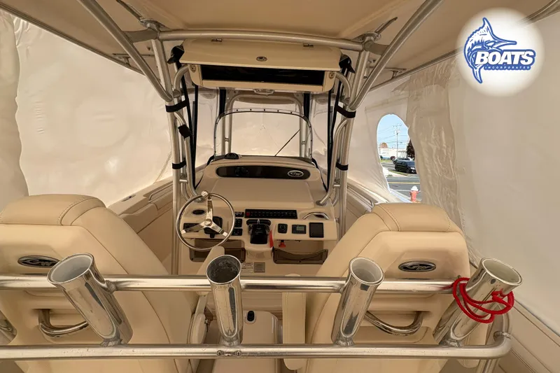 Slide: The Image of 2015 Grady-White Canyon 306 boat interior with steering wheel and rod holders. - 13