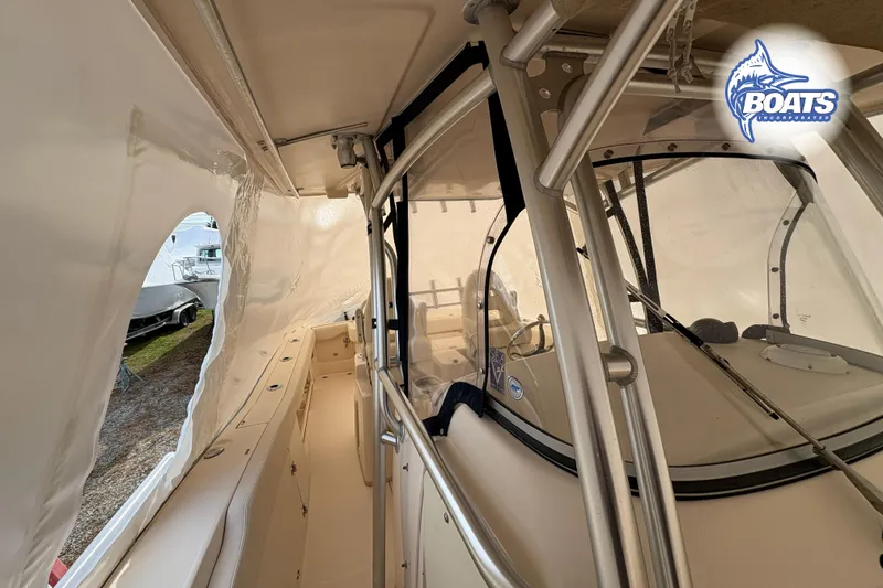 Slide: The Image of 2015 Grady-White Canyon 306 boat interior with protective covering and steering console. - 14