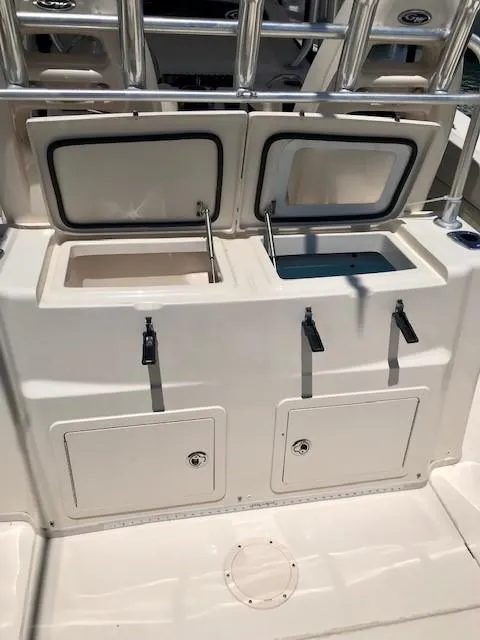 Slide: The Image of 2015 Grady-White Canyon 306 boat with open storage compartments. - 16
