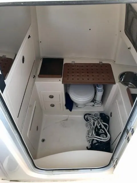 Slide: The Image of 2015 Grady-White Canyon 306 boat interior with toilet and storage compartments. - 17