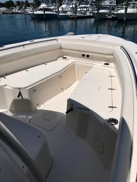 Slide: The Image of 2015 Grady-White Canyon 306 boat interior, spacious seating, docked at marina. - 19