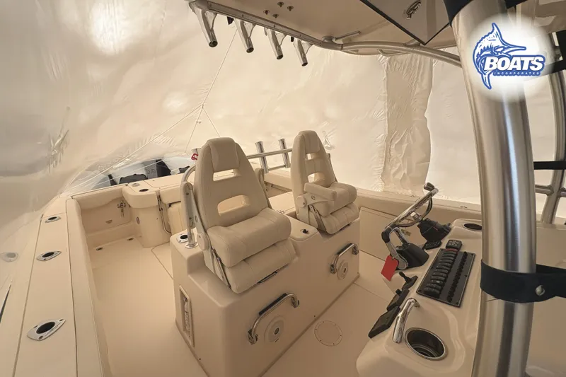 Slide: The Image of 2015 Grady-White Canyon 306 boat interior with helm and seating area. - 2