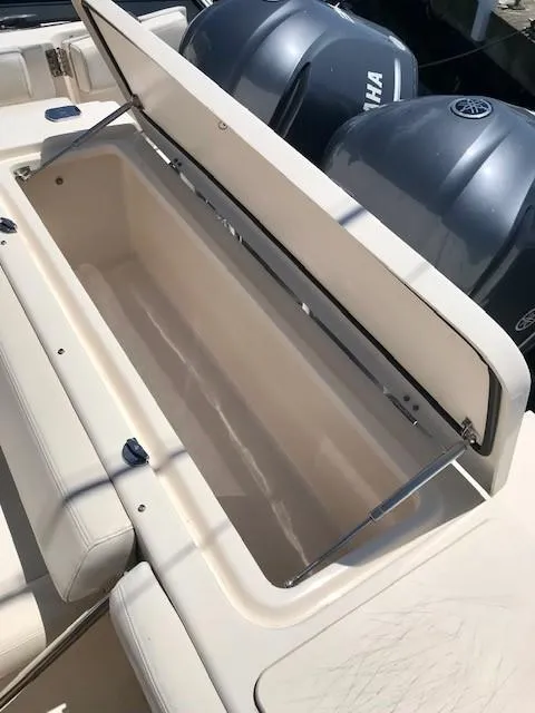 Slide: The Image of 2015 Grady-White Canyon 306 boat with open storage compartment and Yamaha engines. - 22