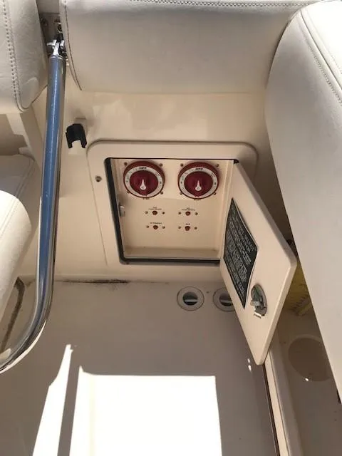 Slide: The Image of 2015 Grady-White Canyon 306 boat interior with open control panel and red dials. - 25