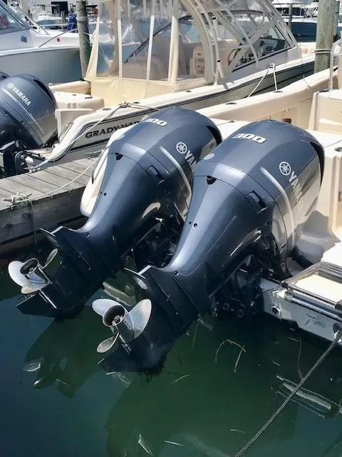 Slide: The Image of 2015 Grady-White Canyon 306 boat with dual Yamaha outboard engines docked at marina. - 27