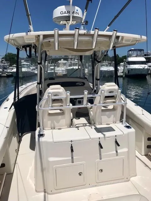Slide: The Image of 2015 Grady-White Canyon 306 boat with dual seats and Garmin radar, docked in marina. - 3
