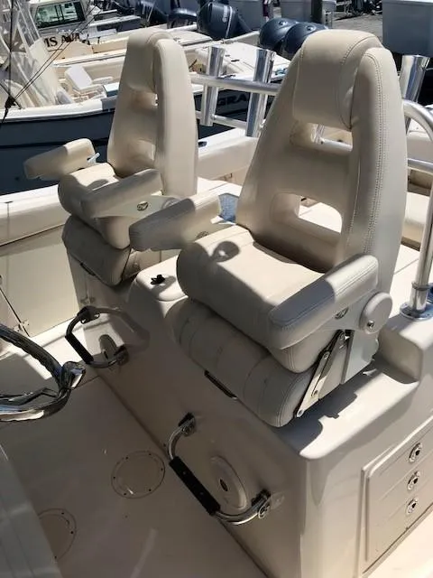 Slide: The Image of 2015 Grady-White Canyon 306 boat seats, featuring plush white upholstery and armrests. - 4