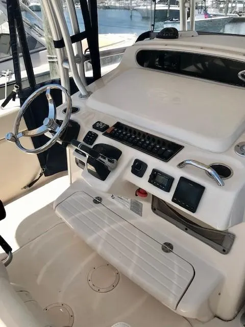 Slide: The Image of 2015 Grady-White Canyon 306 boat helm with steering wheel and control panel. - 5