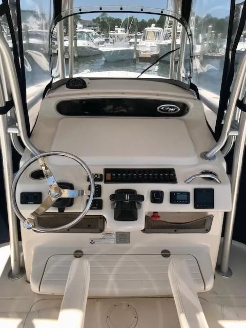 Slide: The Image of 2015 Grady-White Canyon 306 boat dashboard with steering wheel and controls. - 6