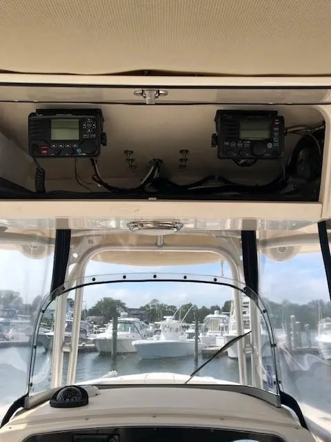 Slide: The Image of 2015 Grady-White Canyon 306 boat dashboard with electronics, docked at marina. - 9