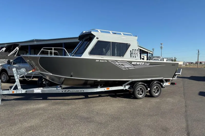 The Image of 2025 Hewescraft 220 Ocean Pro ET HT boat on trailer, parked outdoors. - 1