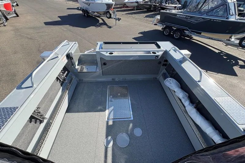 Slide: The Image of 2025 Hewescraft 220 Ocean Pro ET HT boat interior, spacious deck, and storage features. - 6