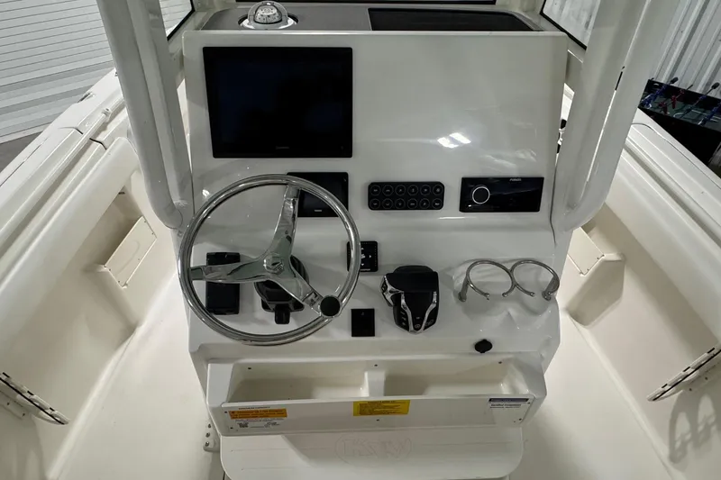 Slide: The Image of 2026 Key West 239 FSR boat console with steering wheel and modern controls. - 12