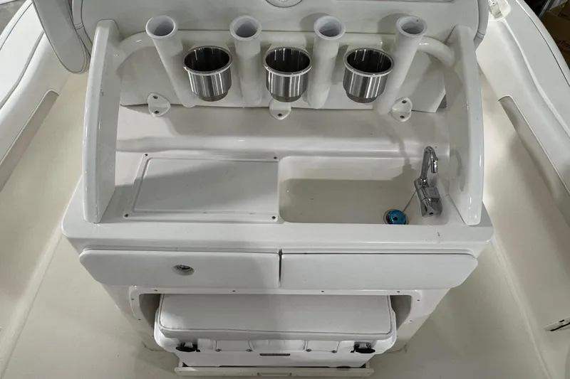 Slide: The Image of Key West 239 FSR 2026 boat console with rod holders and sink. - 15