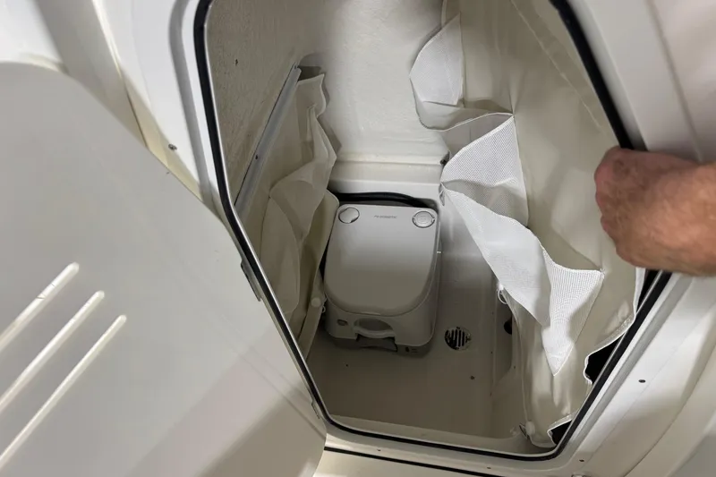Slide: The Image of Interior of 2026 Key West 239 FSR boat with compact portable toilet. - 18