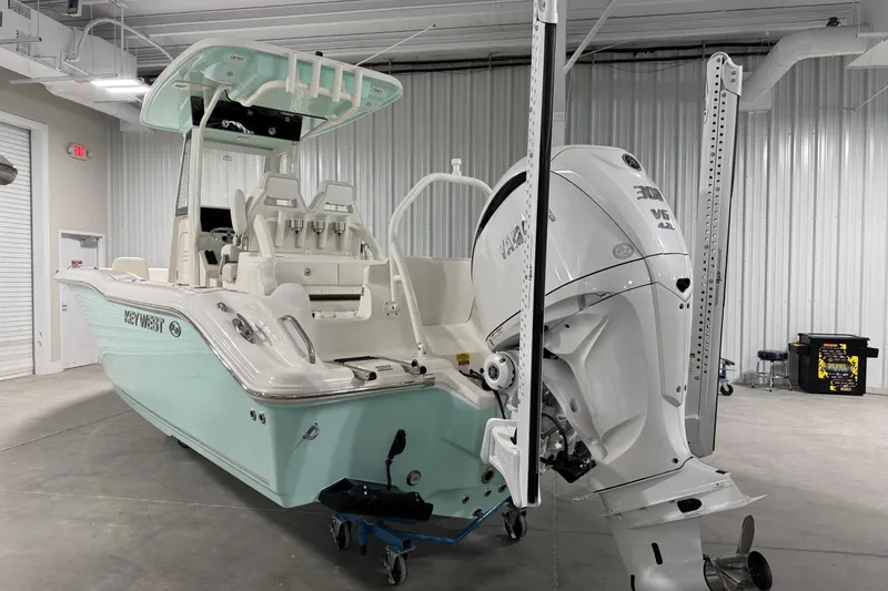 Slide: The Image of 2026 Key West 239 FSR boat with powerful engine in a garage setting. - 3