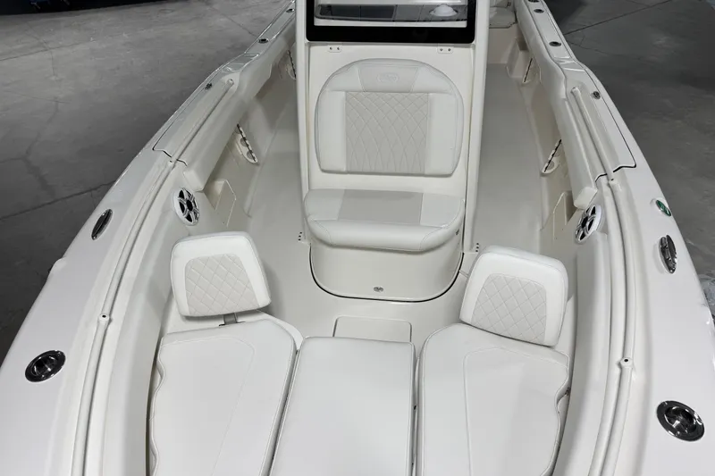 Slide: The Image of 2026 Key West 239 FSR boat interior with white cushioned seating and modern design. - 4