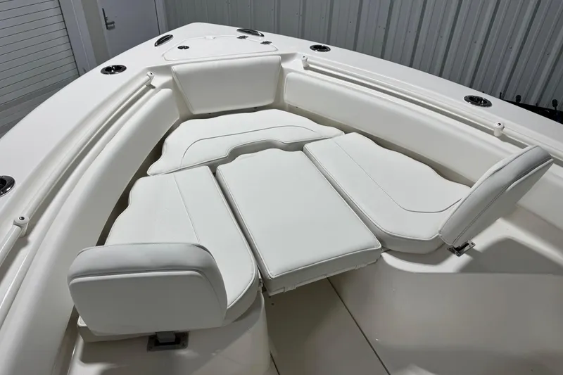 Slide: The Image of 2026 Key West 239 FSR boat interior with white cushioned seating arrangement. - 5