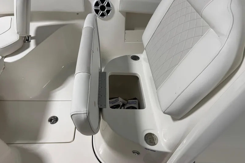 Slide: The Image of 2026 Key West 239 FSR boat interior with white cushioned seating and storage compartment. - 9