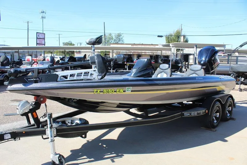 Slide: The Image of 2019 Skeeter ZX225 bass boat on trailer, displayed outdoors. - 16