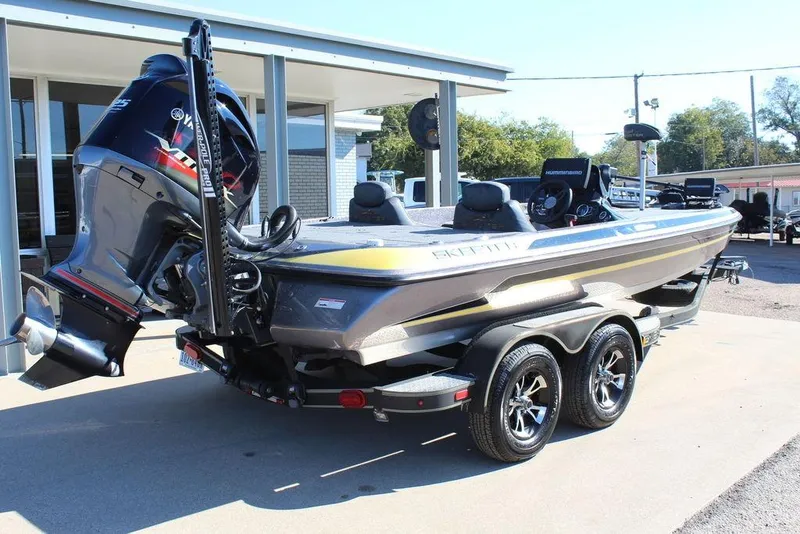 Slide: The Image of 2019 Skeeter ZX225 bass boat with Yamaha outboard motor, parked on a trailer. - 19