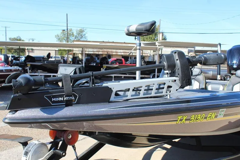 Slide: The Image of 2019 Skeeter ZX225 boat with Minn Kota trolling motor, parked outdoors. - 2
