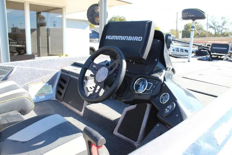 Slide: The Image of 2019 Skeeter ZX225 boat cockpit with steering wheel and Humminbird electronics. - 24