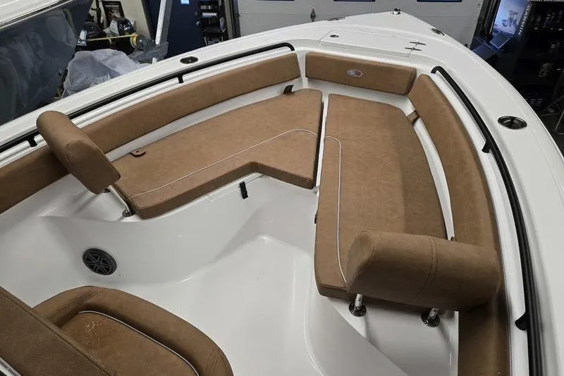 Slide: The Image of 2026 Sea Hunt Ultra 245 SE boat interior with tan cushioned seating. - 10