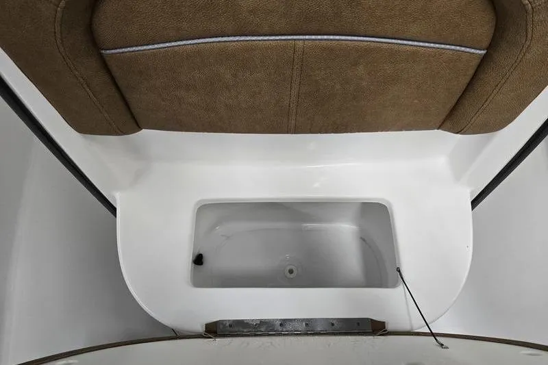Slide: The Image of 2026 Sea Hunt Ultra 245 SE boat interior with storage compartment and cushioned seating. - 15