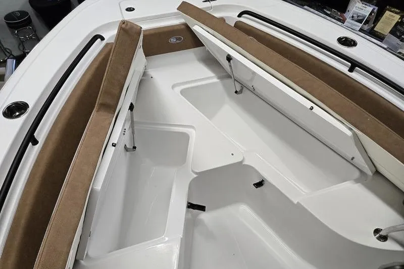Slide: The Image of 2026 Sea Hunt Ultra 245 SE boat interior with cushioned seating and storage compartments. - 16