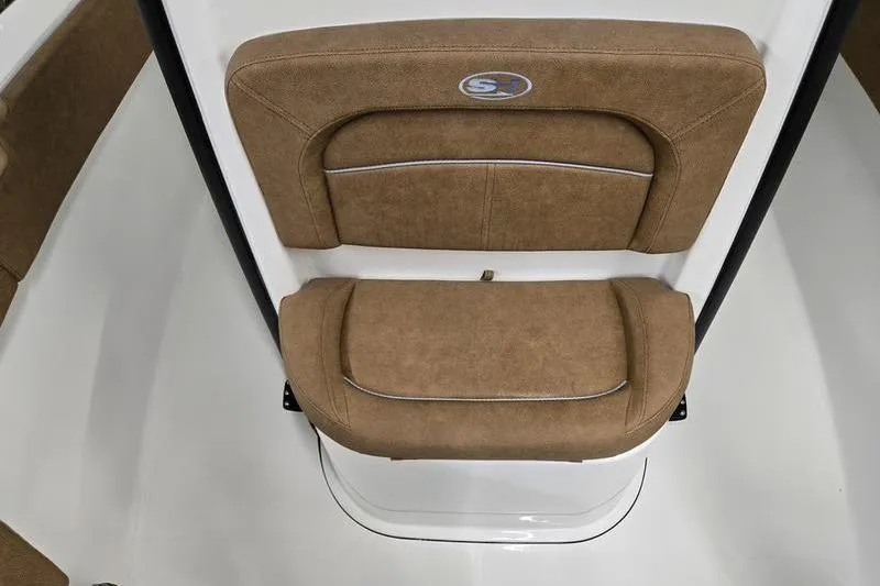 Slide: The Image of 2026 Sea Hunt Ultra 245 SE boat seat with brown upholstery and logo detail. - 17