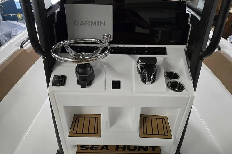 Slide: The Image of 2026 Sea Hunt Ultra 245 SE boat console with Garmin navigation and controls. - 8