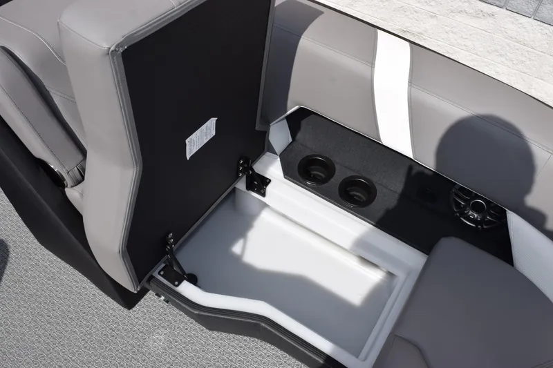 Slide: The Image of Open storage compartment in 2026 Evotti 521 CS boat with speakers and gray seating. - 23