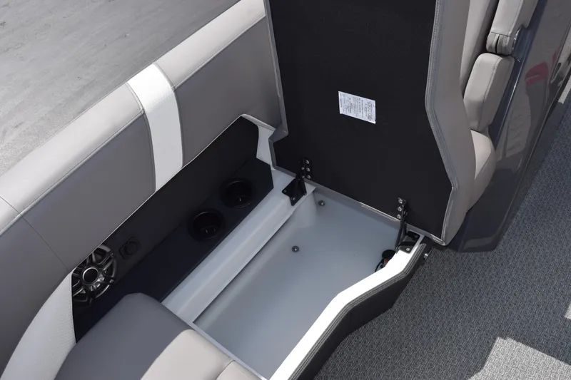 Slide: The Image of Open storage compartment in 2026 Evotti 521 CS boat, featuring cup holders and speaker. - 24