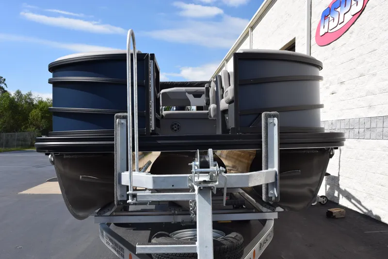 Slide: The Image of 2026 Evotti 521 CS pontoon boat on trailer, parked outside a building. - 3