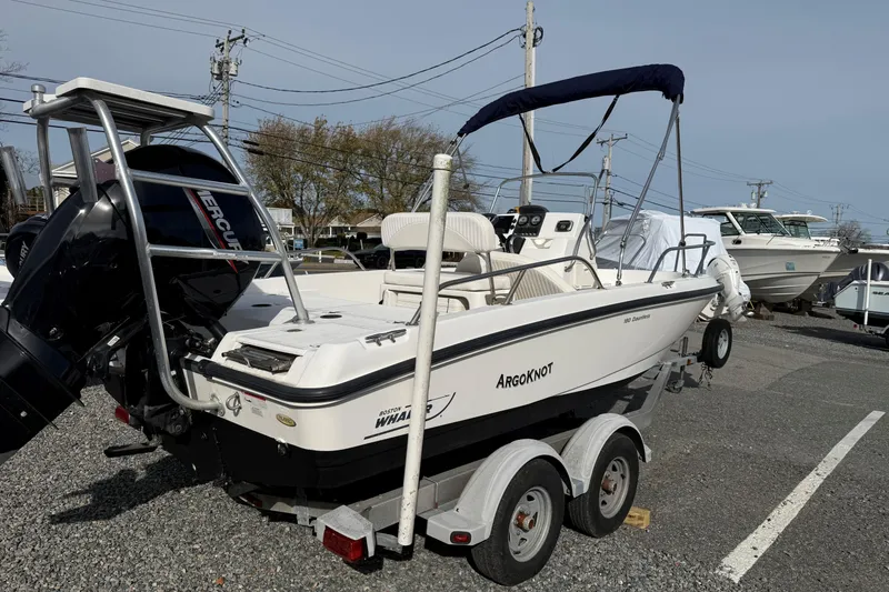 The Image of 2012 Boston Whaler 180 Dauntless boat on EZ Loader trailer, parked outdoors. - 0