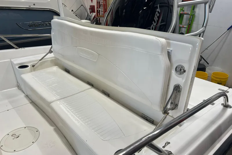 Slide: The Image of 2012 Boston Whaler 180 Dauntless boat on trailer with Mercury engine, outdoor setting. - 10