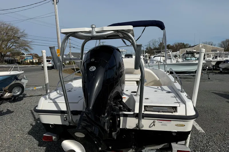 Slide: The Image of 2012 Boston Whaler 180 Dauntless with Mercury engine in a workshop setting. - 2