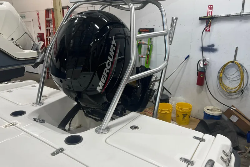 Slide: The Image of 2012 Boston Whaler 180 Dauntless boat in a garage with canopy and railing. - 3