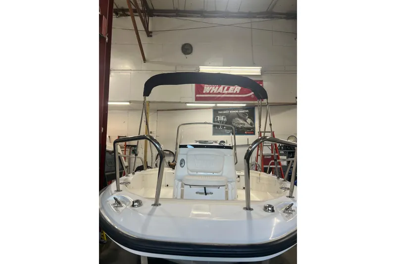 Slide: The Image of 2012 Boston Whaler 180 Dauntless boat interior with white seating and railings. - 4