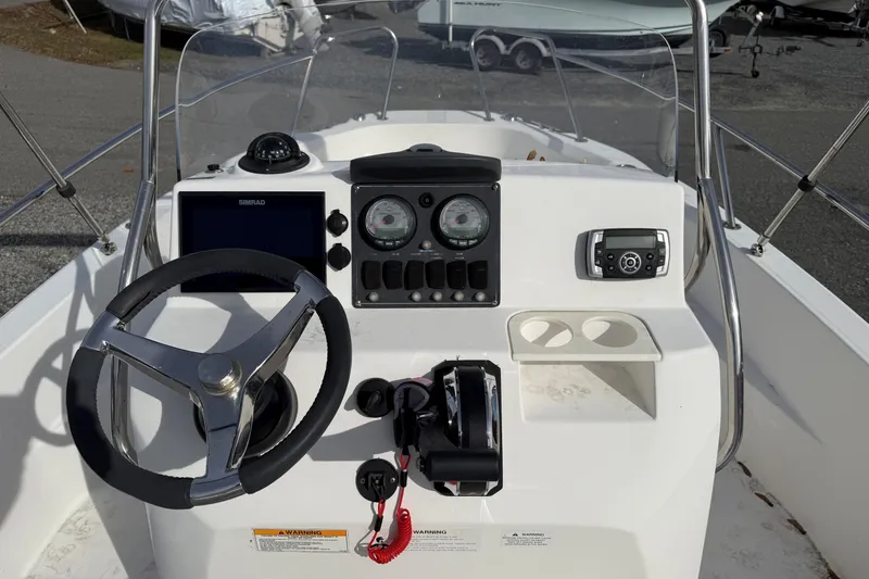 Slide: The Image of 2012 Boston Whaler 180 Dauntless boat interior with steering console and seating. - 6