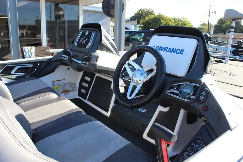 Slide: The Image of 2016 Skeeter FX21 Limited Edition boat interior with steering wheel and Lowrance display. - 17