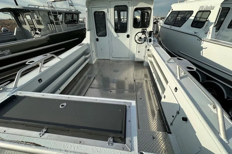 Slide: The Image of 2026 Hewescraft 270 Alaskan boat interior with spacious deck and steering console. - 4