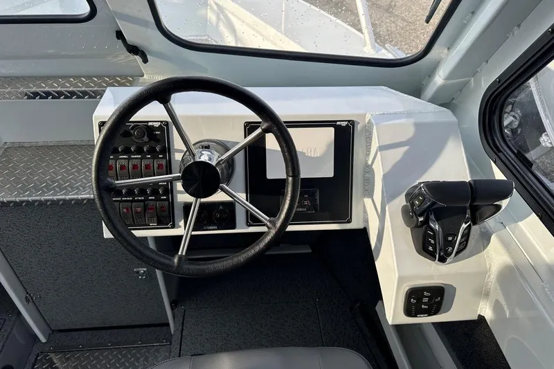 Slide: The Image of Helm of 2026 Hewescraft 270 Alaskan boat with steering wheel and controls. - 8
