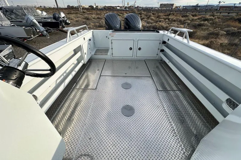Slide: The Image of 2026 Hewescraft 270 Alaskan boat interior with metal flooring and dual engines. - 9